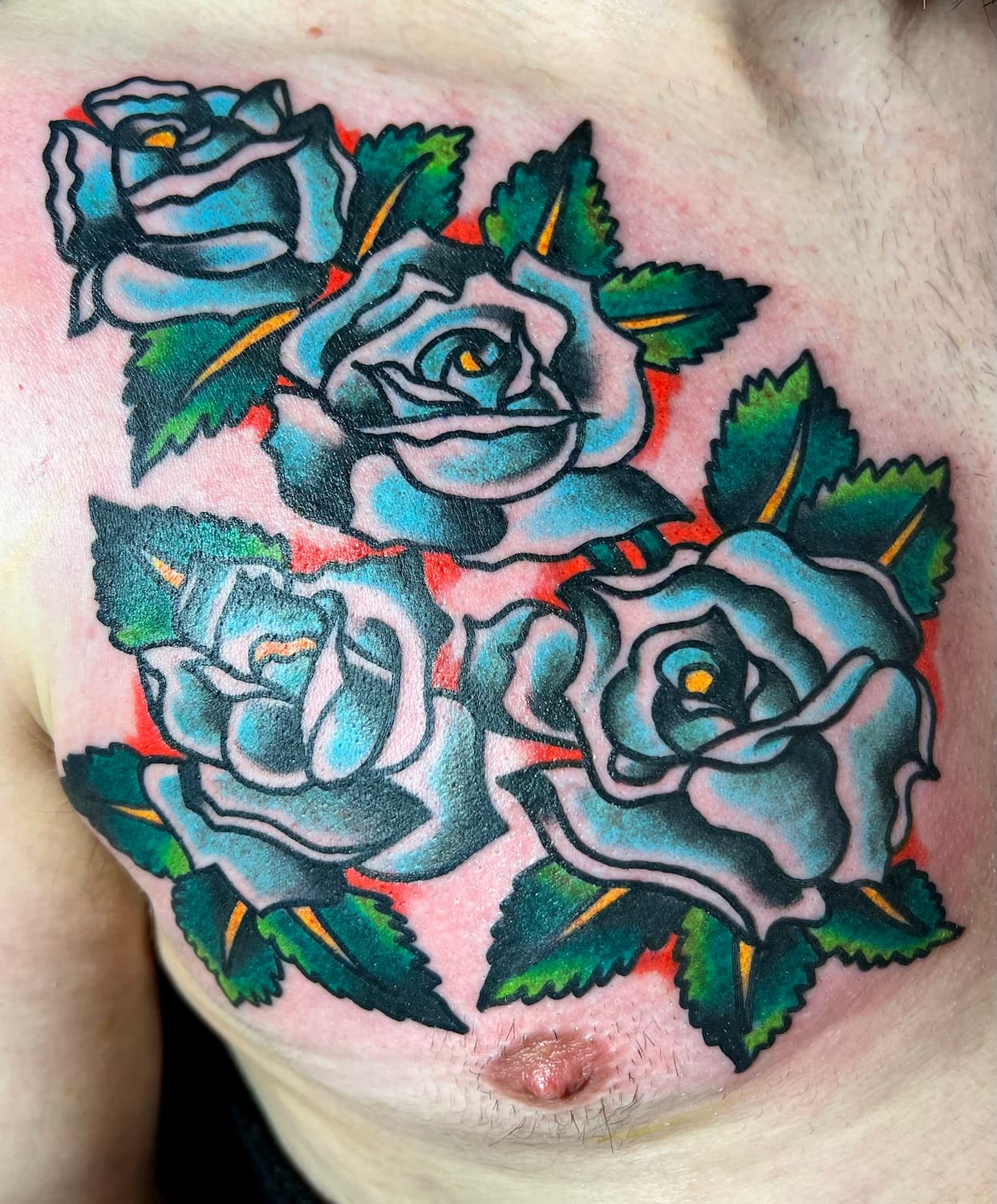 Tattoo of blue roses on chest