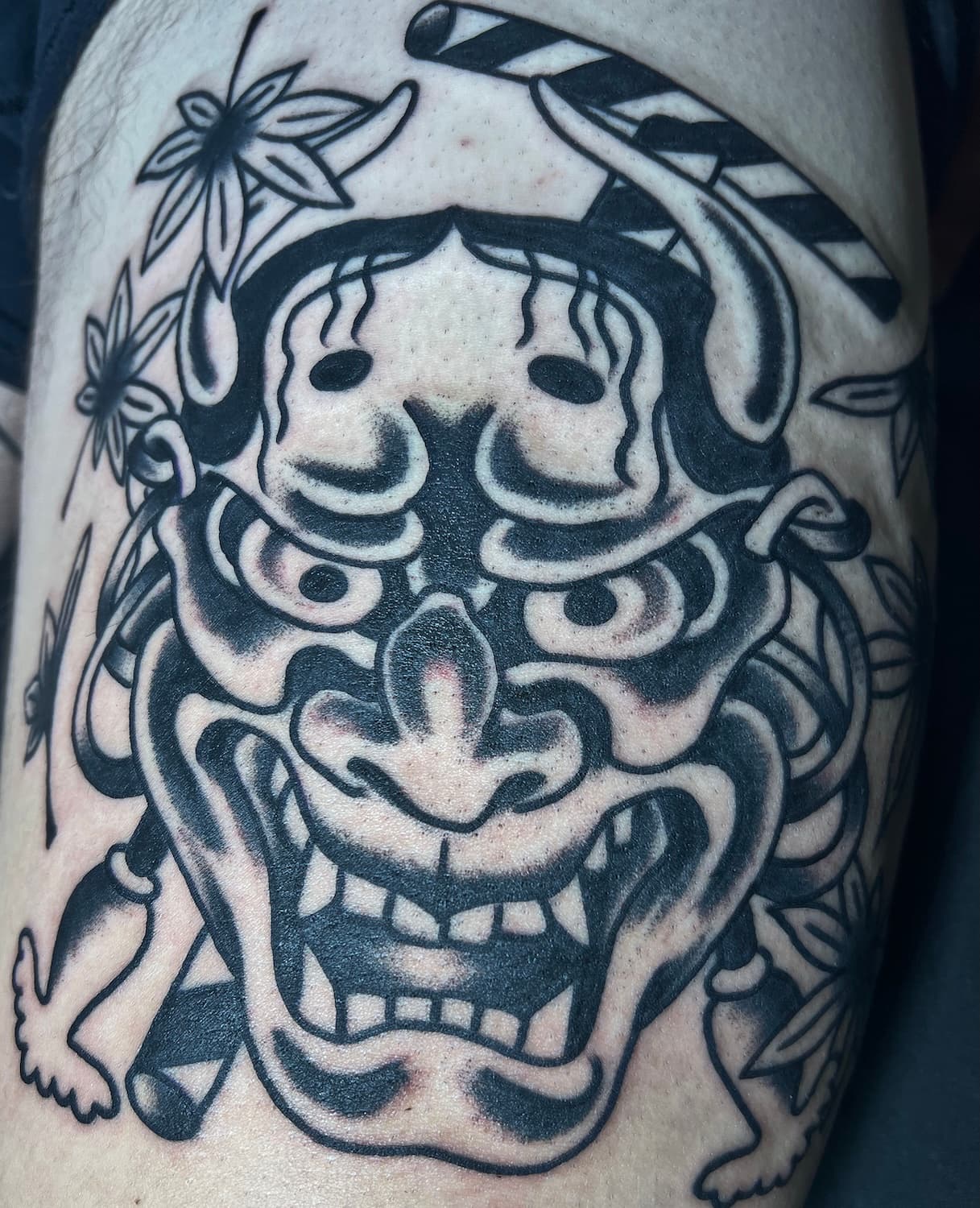 Tattoo of black Hannya mask