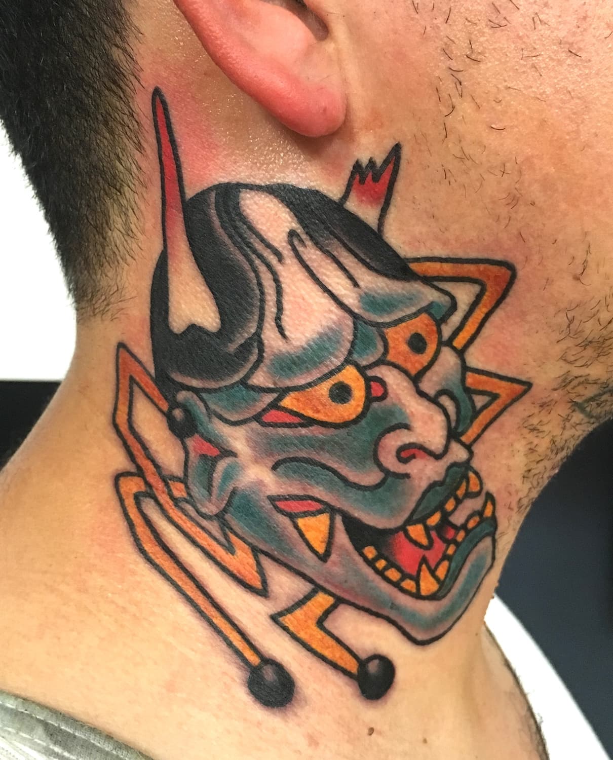 Tattoo of Hannya mask on neck