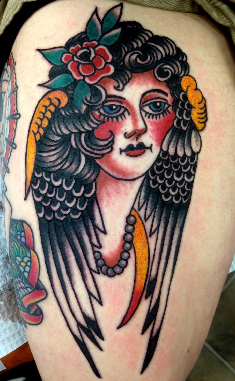 Tattoo of lady head with wings