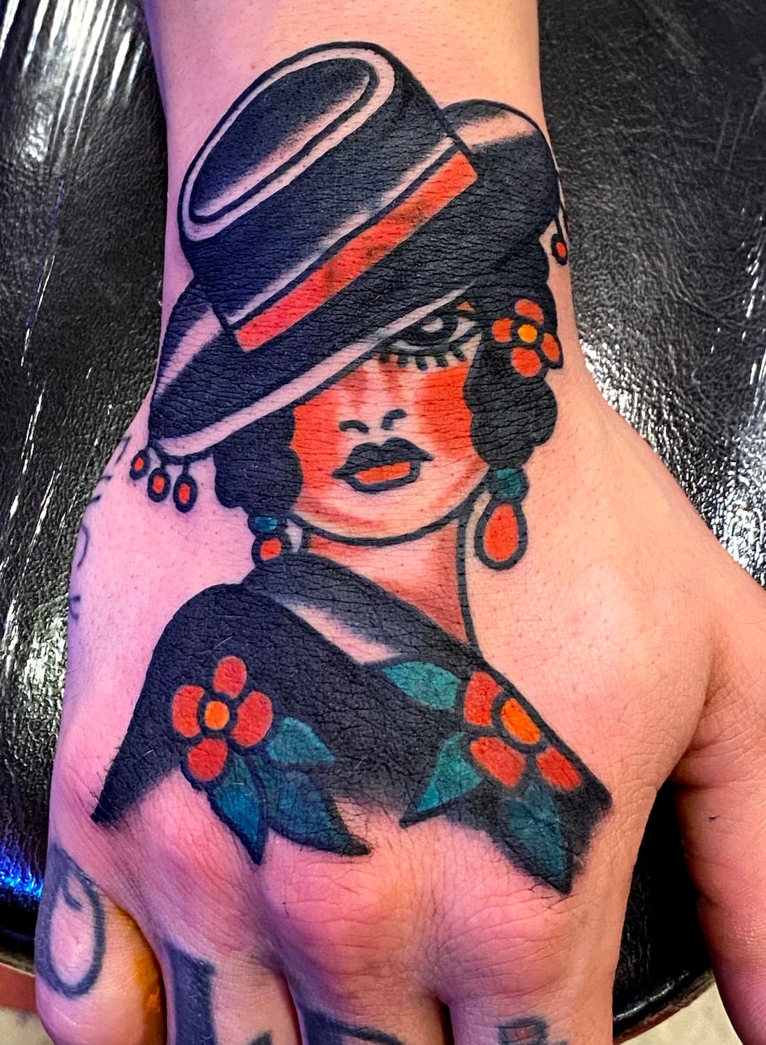 Tattoo of lady head on top of hand