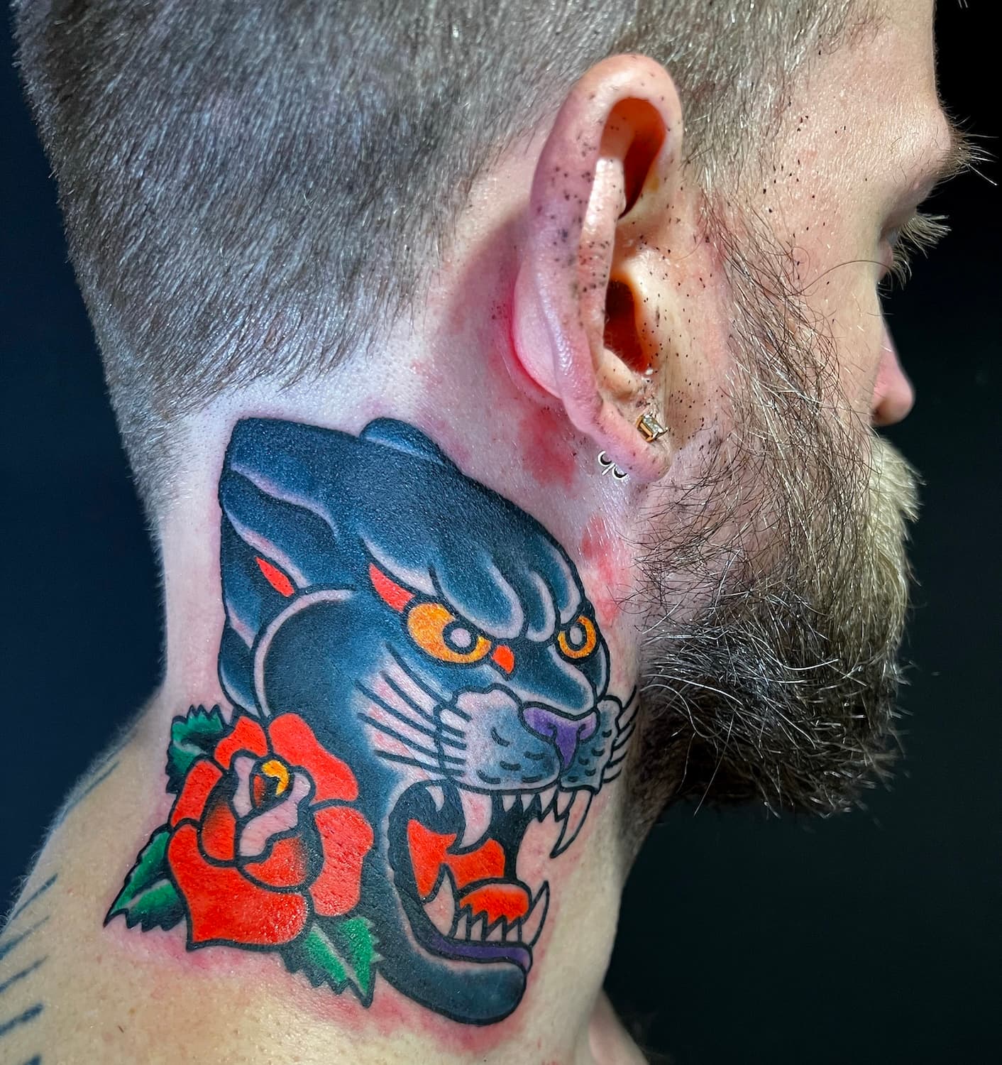 Tattoo of panther head on neck