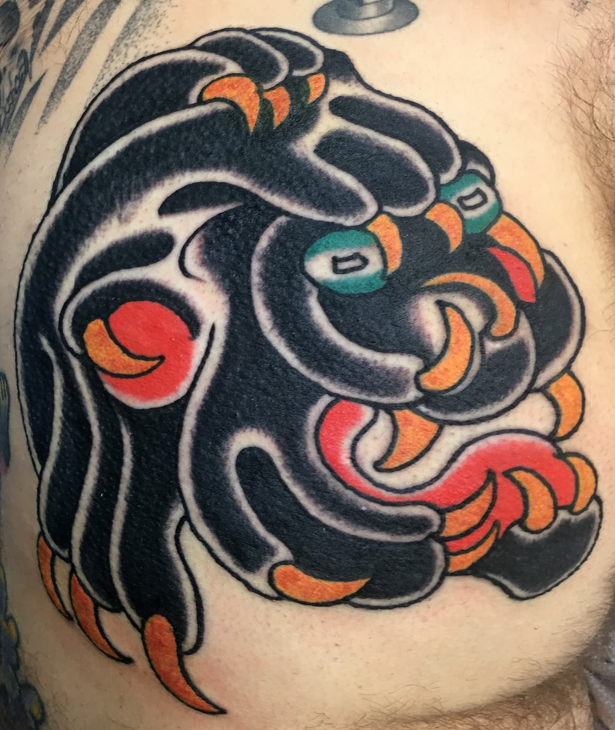 Tattoo of panther head on lower back