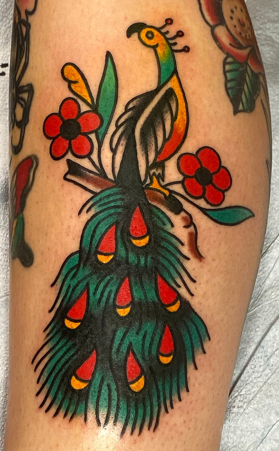 Tattoo of peacock on leg