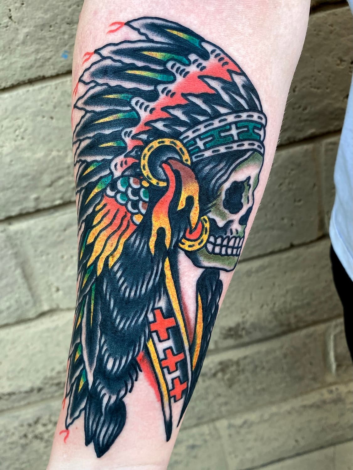 Tattoo of skull with headdress