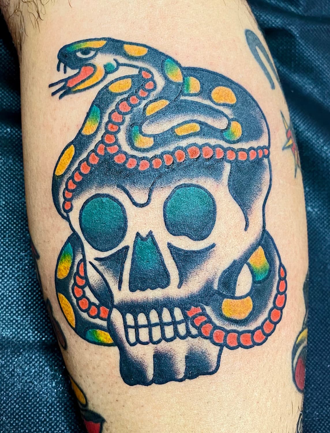 Tattoo of snake and skull