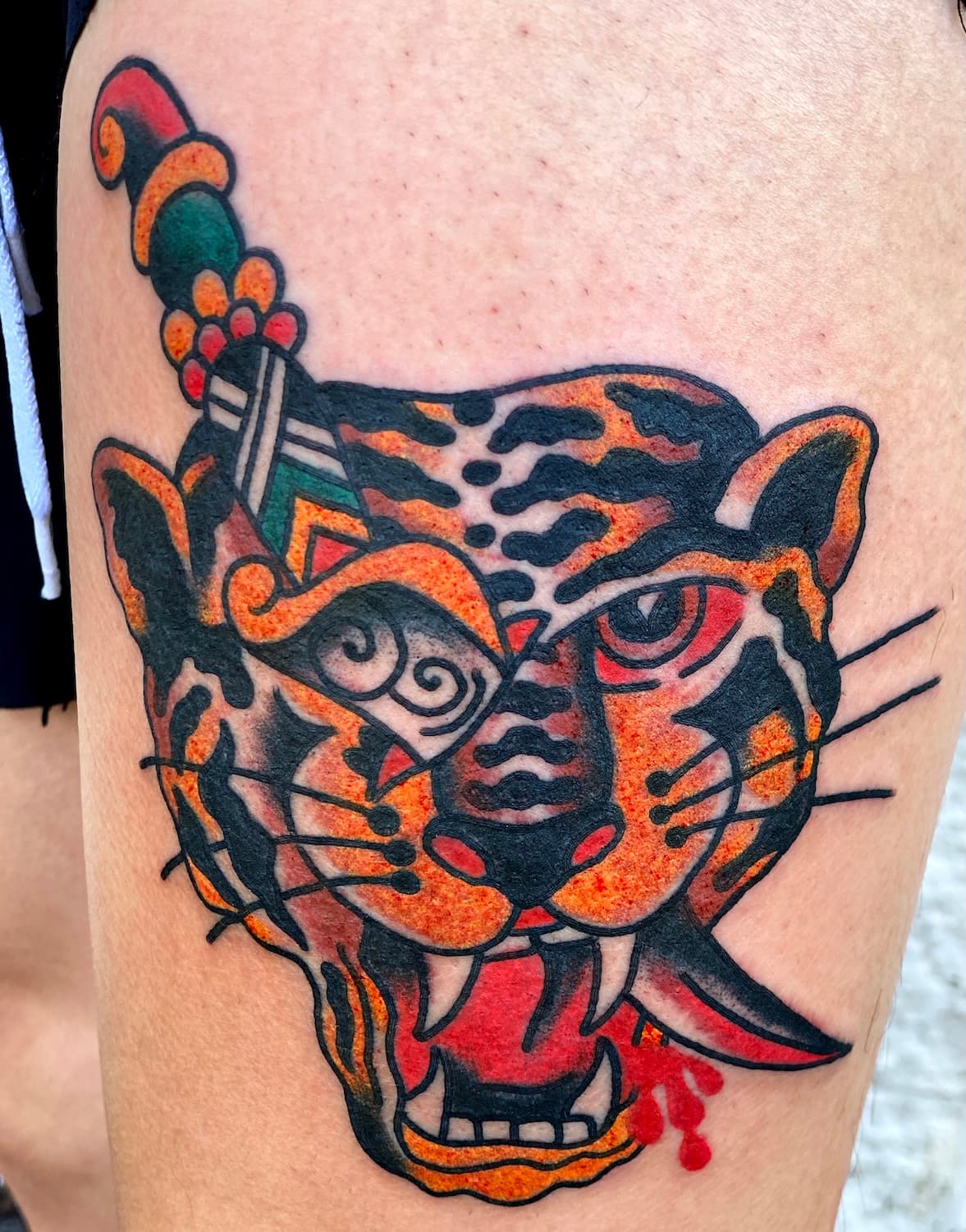 Tattoo of tiger with dagger