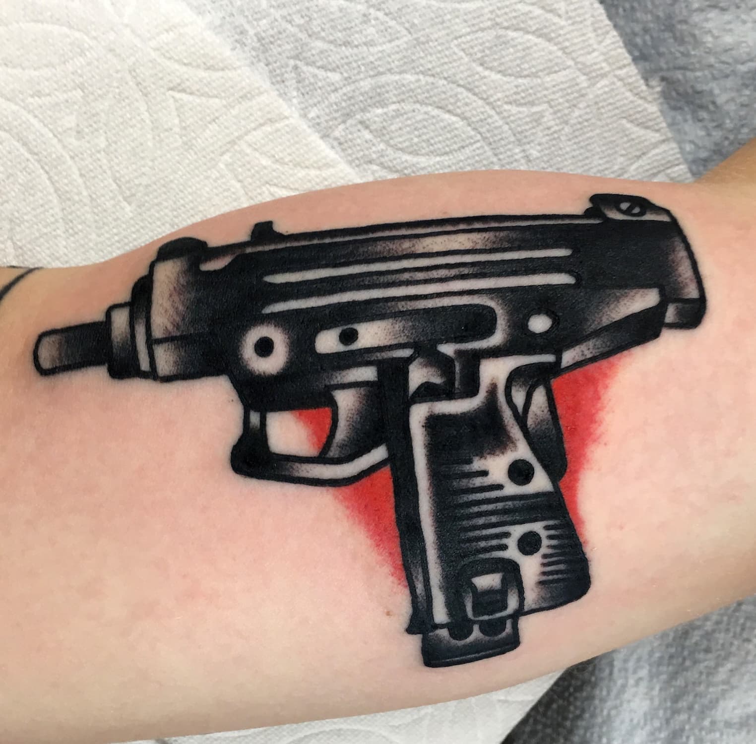 Tattoo of uzi gun on arm