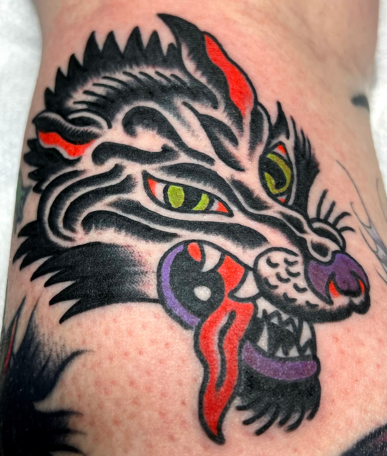 Tattoo of wolf on leg